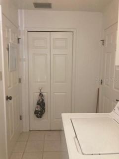 Inside laundry with large closet pantry.