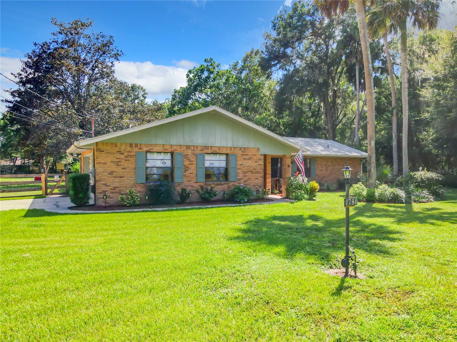 Front of home, with paved driveway to side garage