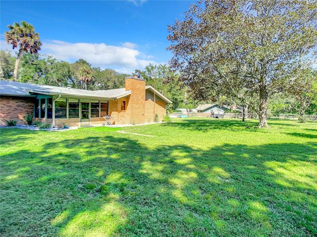 Back of home with enclosed porch
