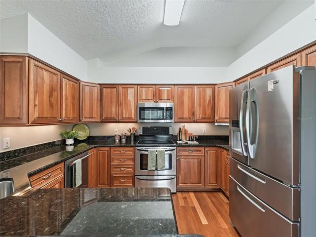 Modern Kitchen Conveniences w/ Beautiful cherry cabinets w/pull-outs, granite counter, & stainless steel appliance