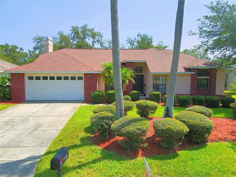 CURB APPEAL! Beautiful, lush tropical landscaping welcomes you home.