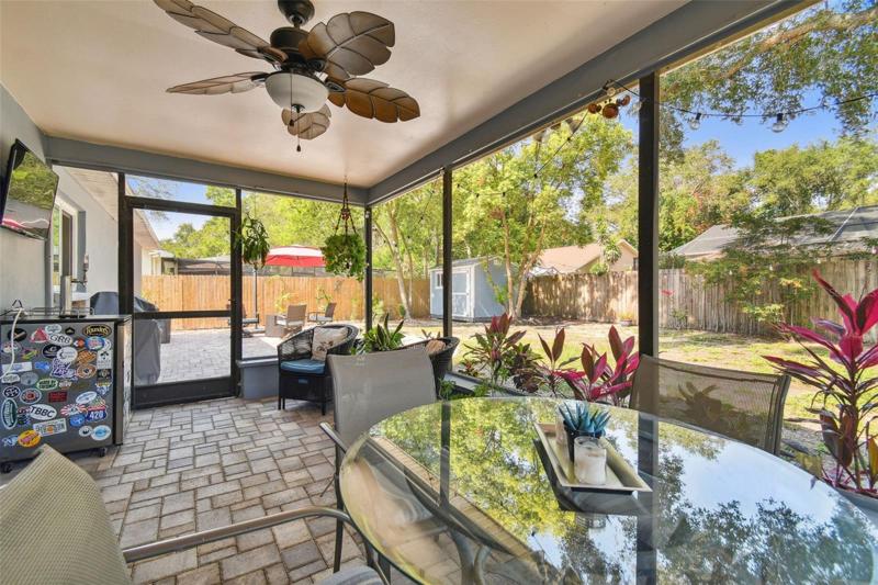 Screened in patio area with a fan