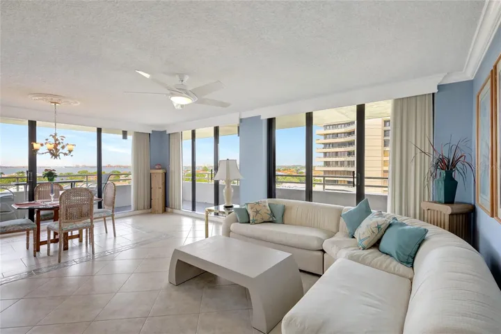 Living room open floor plan. Floor to ceiling glass window walls open to 75' wrap-a-round balcony.