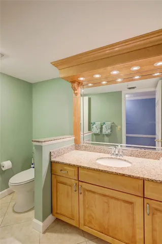 Guest vaniety,  designer remodeled wood cabinetry + granite counter top.