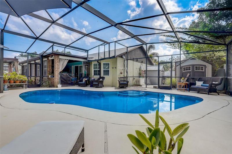 After you’re done splashing for the day prepare dinner in the OUTDOOR KITCHEN with a BUILT-IN SEDONA GRILL, tongue and groove ceiling, beverage fridge and kegerator all tucked away in the ENCLOSED and SCREENED LANAI!