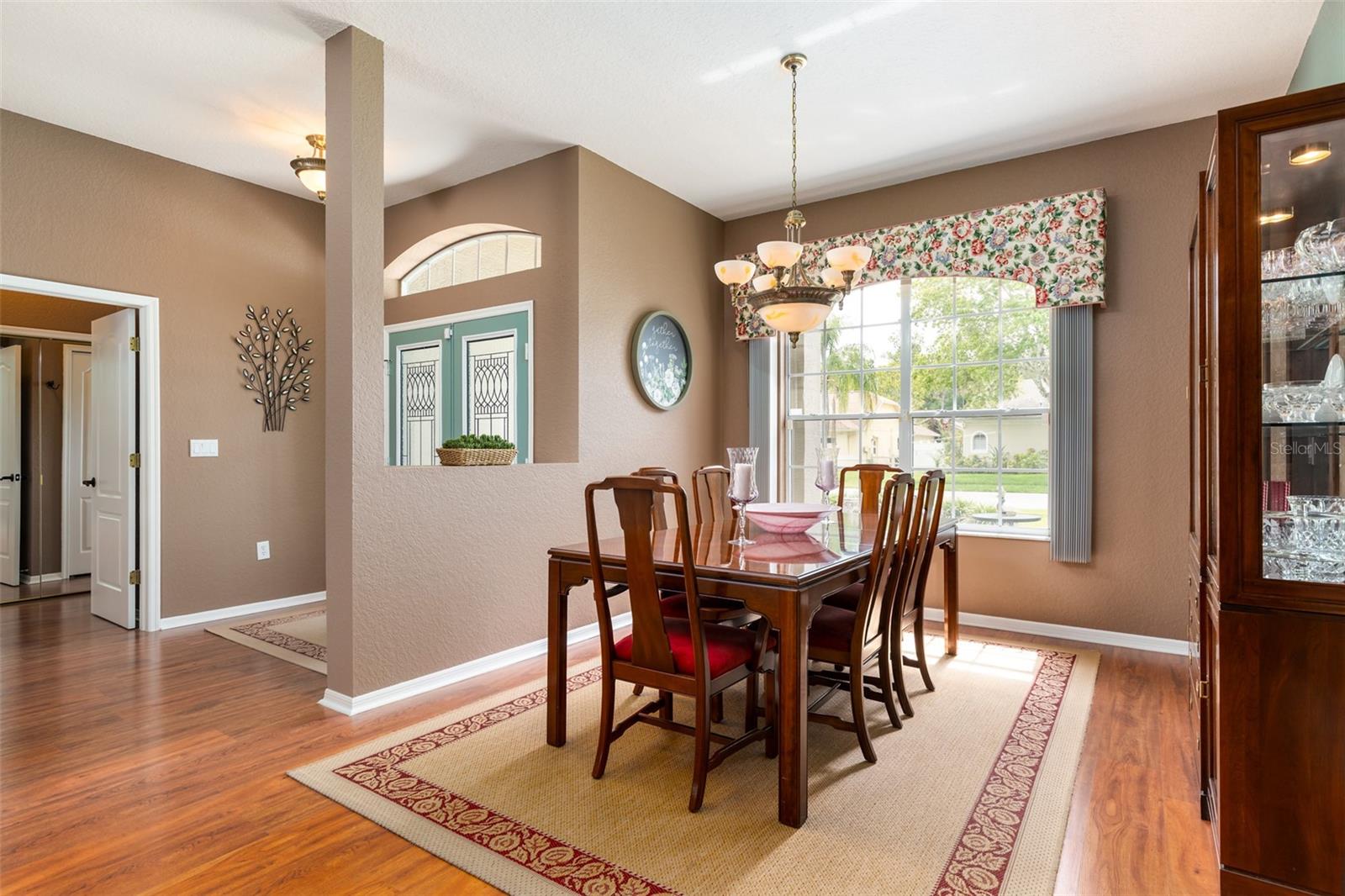 The Formal Dining Room at the front has a large window looking out over the front patio.