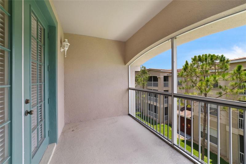 This third floor unit delivers a **SCREENED BALCONY,** in-unit laundry, covered parking, the building has a tile roof and the community offers great amenities