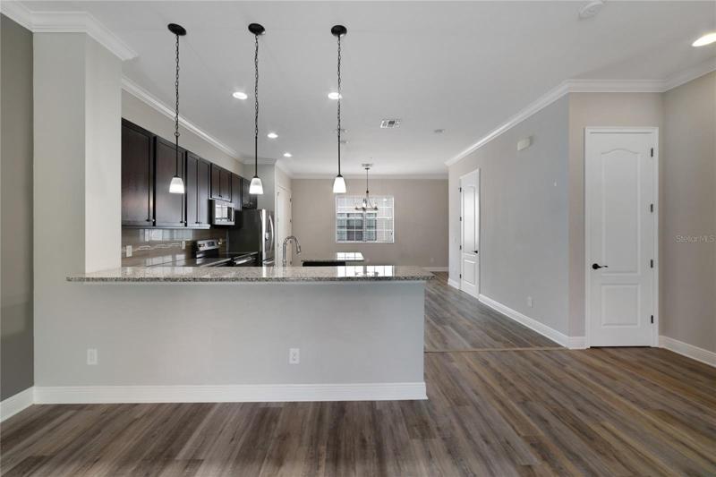 The second floor is home to your main living area with beautiful WOOD LAMINATE FLOORS throughout the bright open space, CROWN MOLDING, and French door access to the patio!