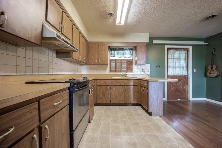 Open kitchen with access to the front entrance and dining area