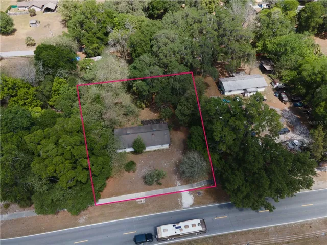 Aerial view of home with view of the roof and surrounding area