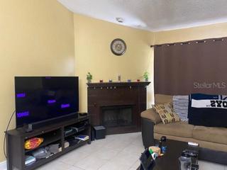 The living room provides natural light with the sliding glass doors.