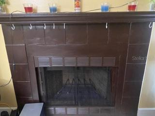 A wood burning fireplace is in the living room.