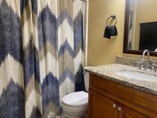 The guest bathroom with granite countertops.