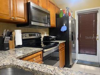 Another view of the kitchen with a door leading out to a front patio area - great for a grill.
