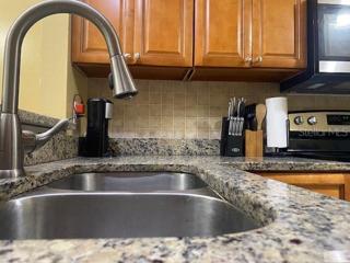 Granite countertops and a backsplash to give a nice look to the kitchen.