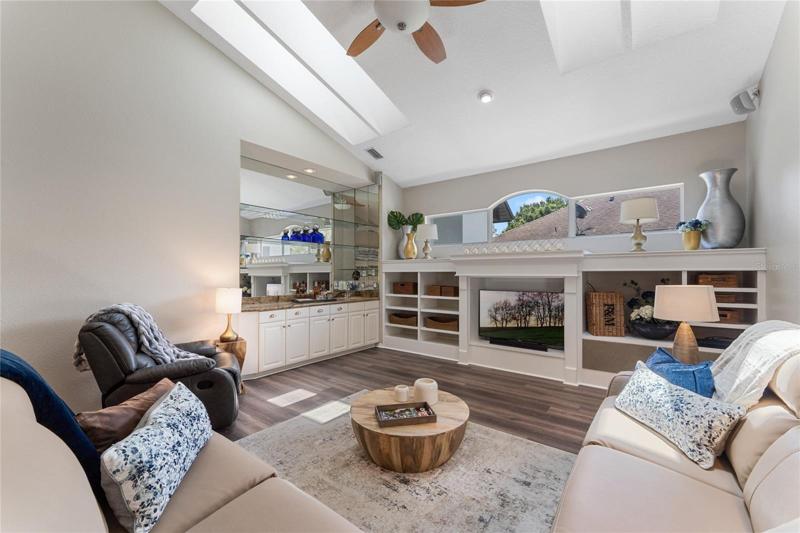 The home features an expansive family room with a full wet bar and built in library shelves.