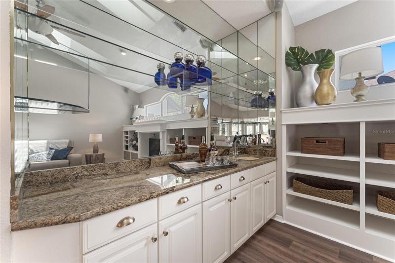 View of the family room wet bar with granite countertops.