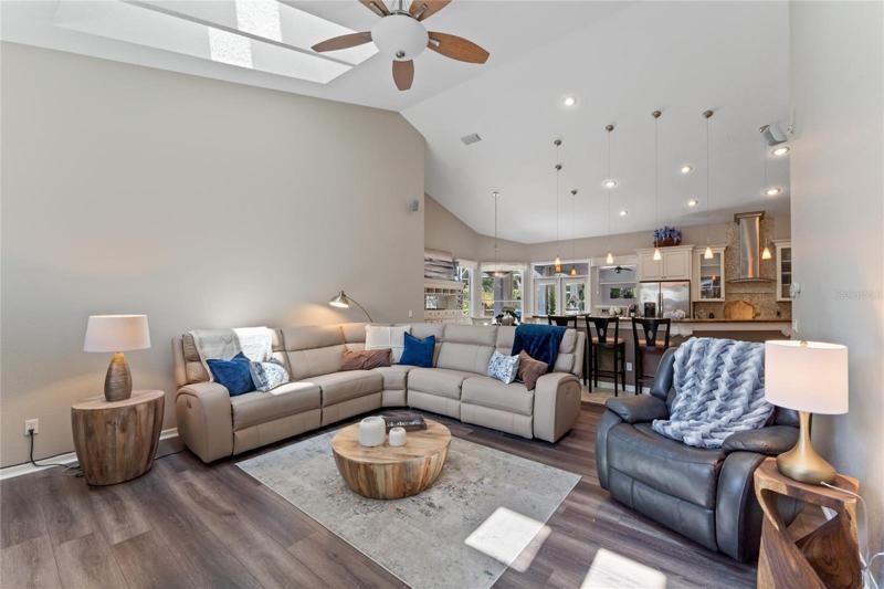 The family room features skylights and new luxury vinyl flooring.
