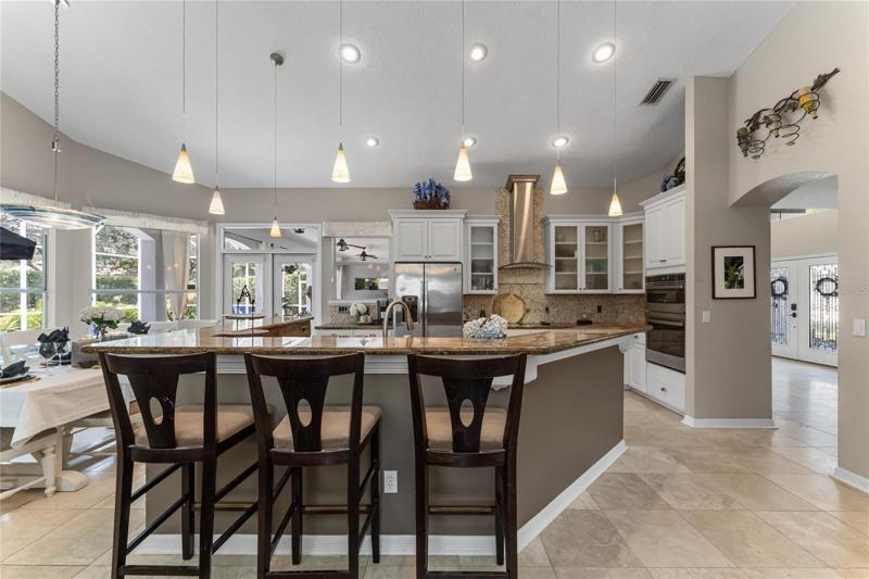 The open concept kitchen is sure to please the home chef with a built in breakfast bar, granite counters and updated cabinets and appliances.