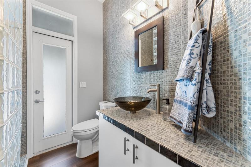View of the full ensuite bath with walk in shower and pool door access.