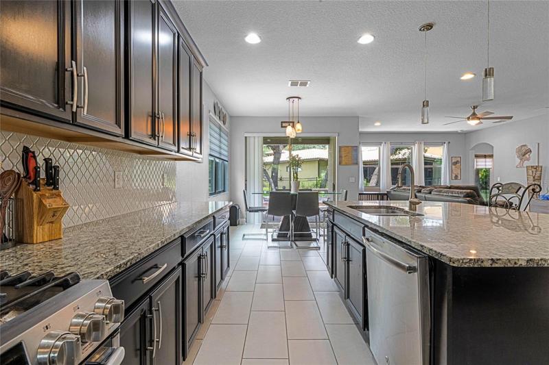 Kitchen with gas stove and stone countertops