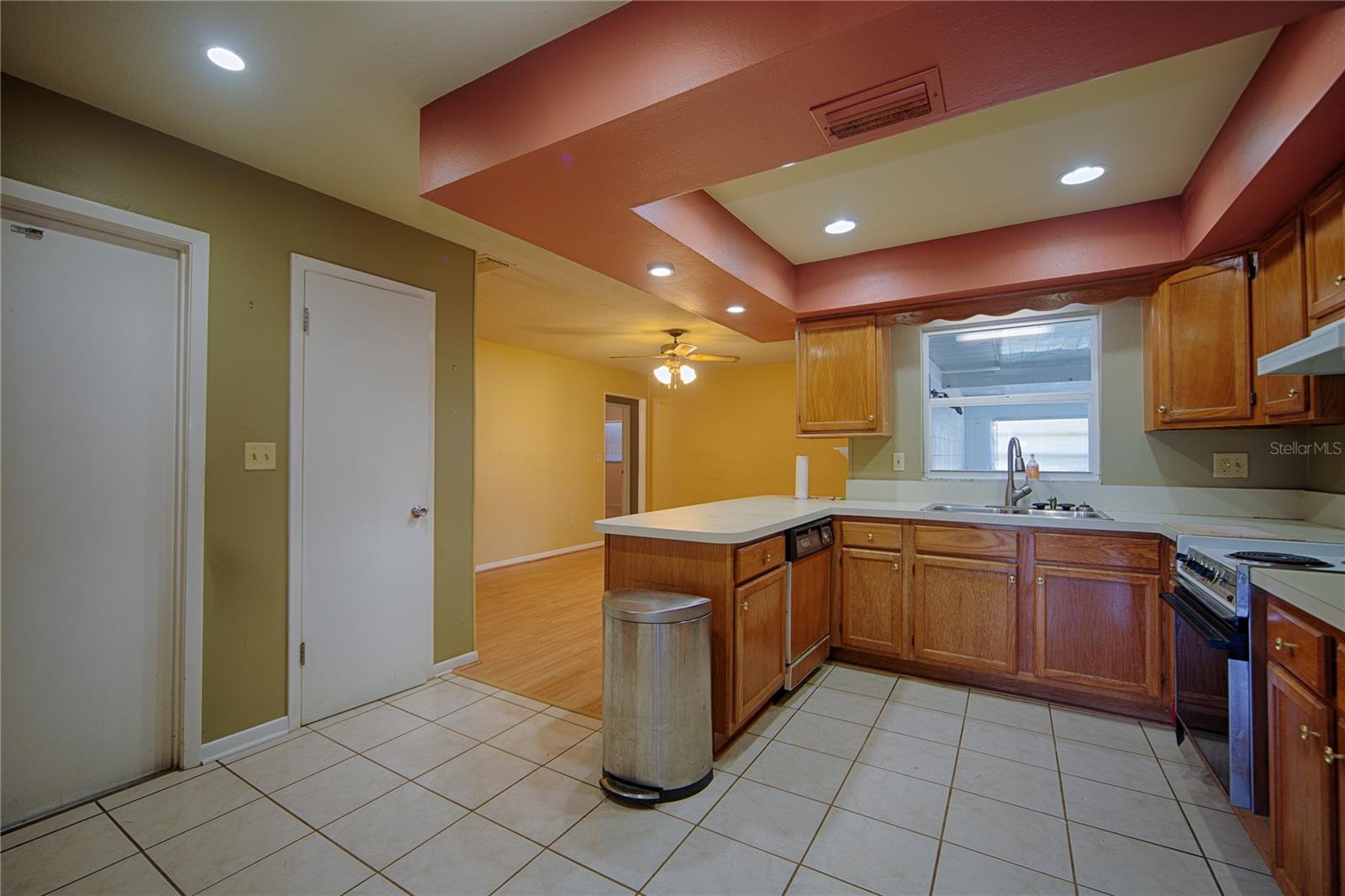 Kitchen, doors to pantry and garage