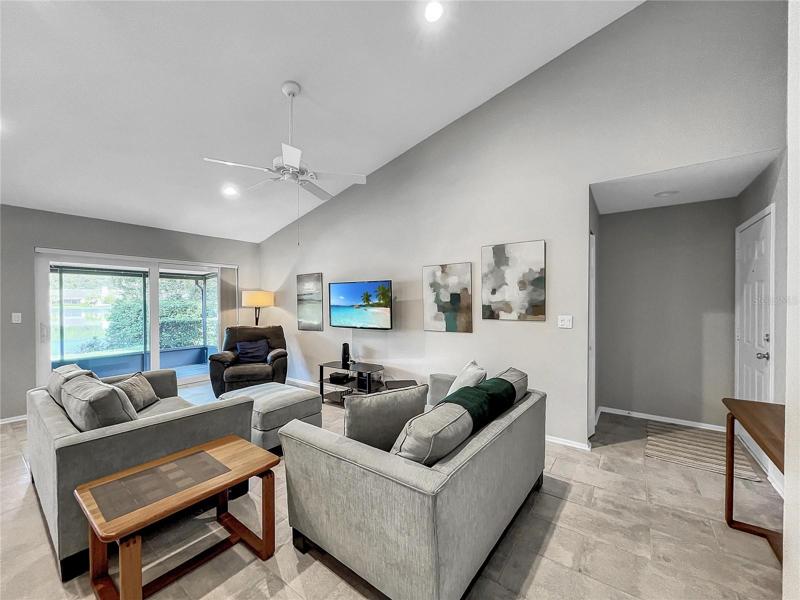 Living Room with Vaulted Ceilings and Ceiling Fan