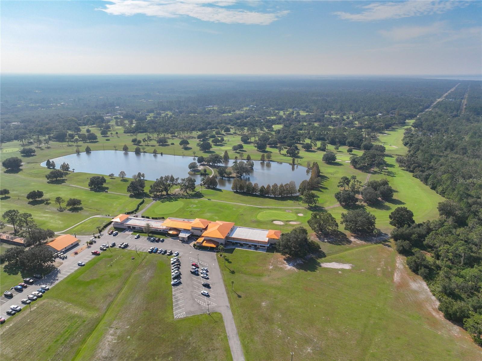 Aerial view of the clubhouse with the golf course in the background