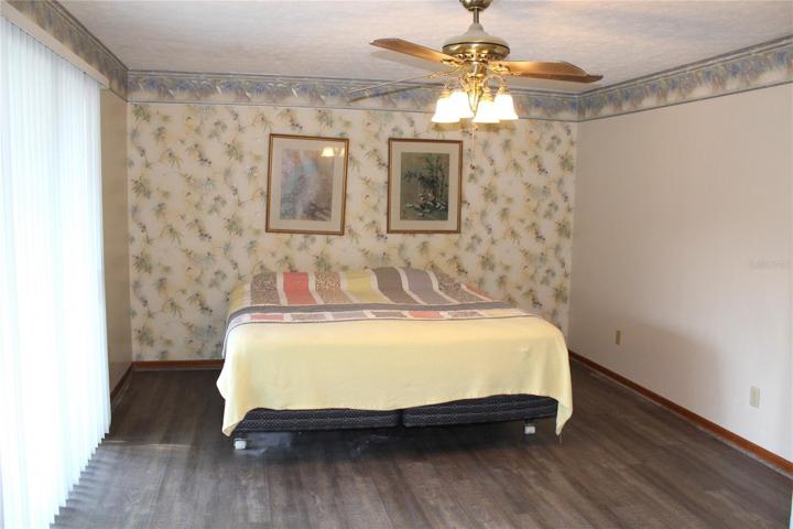 Master Beroom with walk in closet, separate bathroom and sliding glass doors out to patio