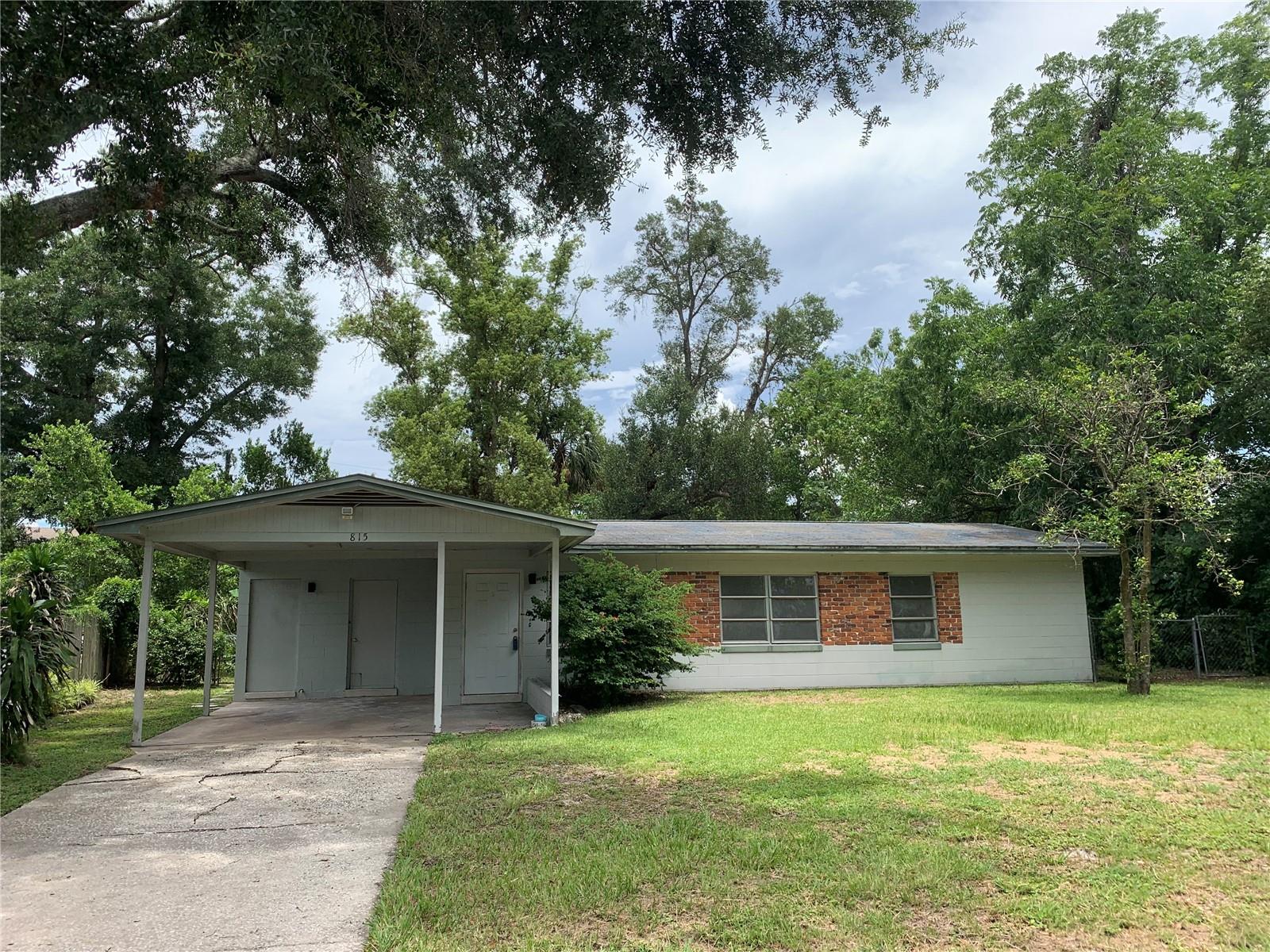Front of home. Many beautiful mature trees surround the property.