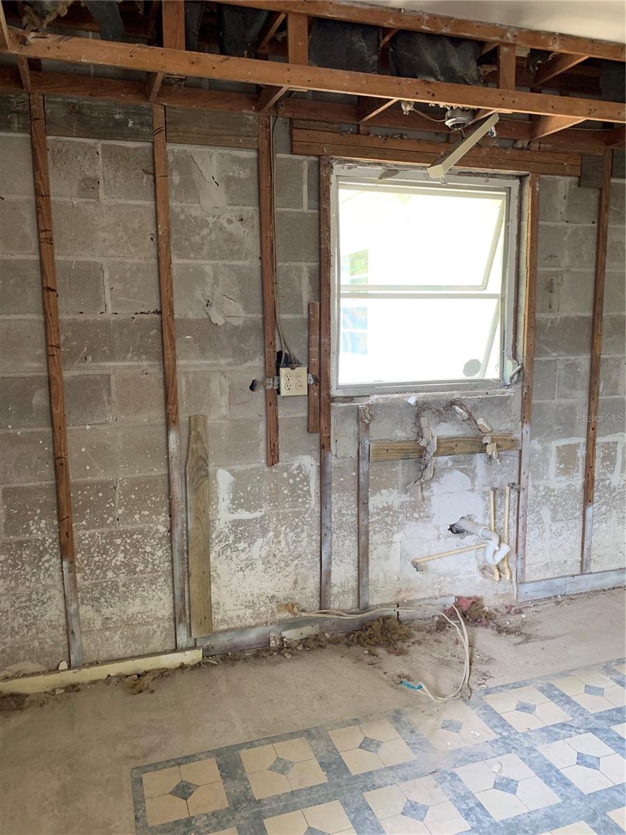 This wall in the Kitchen area was where the sink was. The window looks out to the beautiful backyard.