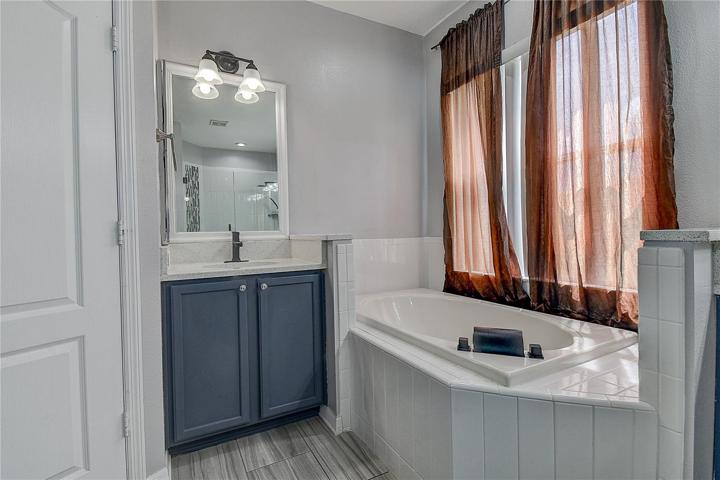Private lavatory and separate vanity.  Linen closet on opposite side.