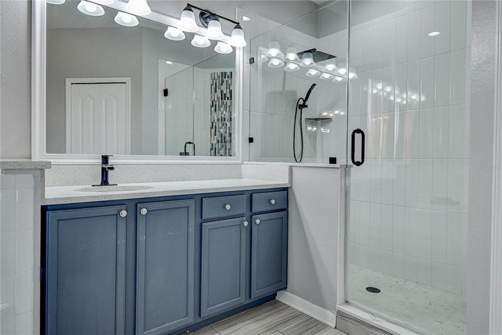 Large vanity with lots of storage.  Beautifully updated shower.