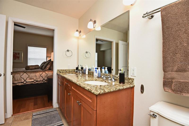 Bathroom view from Closet looking with Bedroom in background
