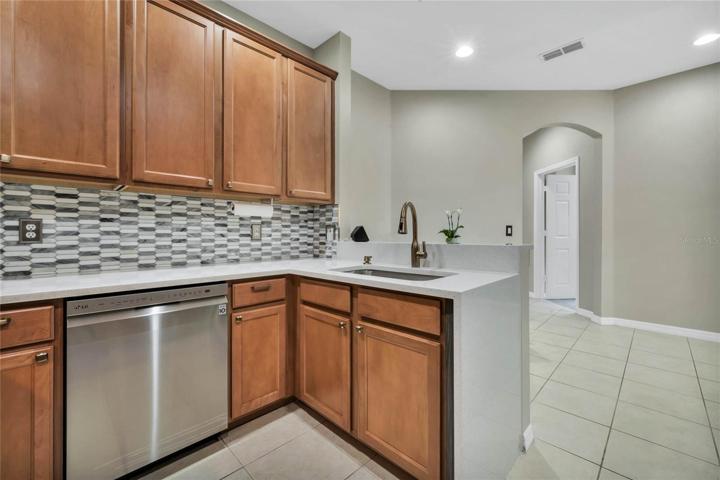 Waterfall quartz countertops, new sink & faucet, backsplash