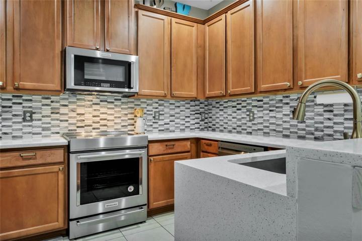 Waterfall quartz counter with upgrade backsplash, sink, faucet, high end appliances