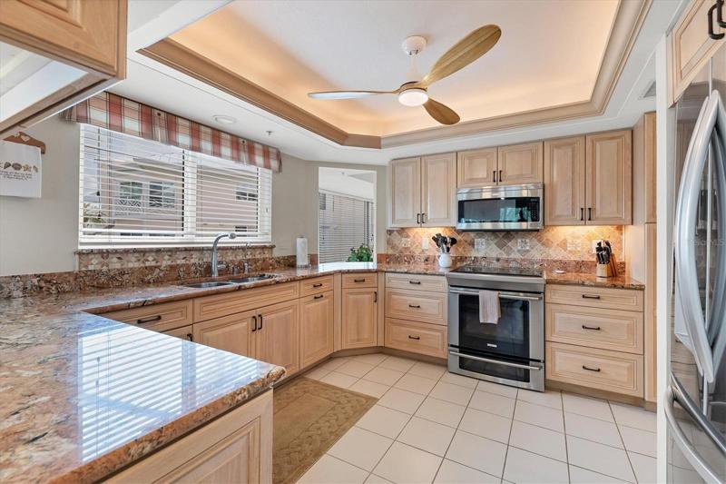 Kitchen is  complimented with stainless appliances & granite