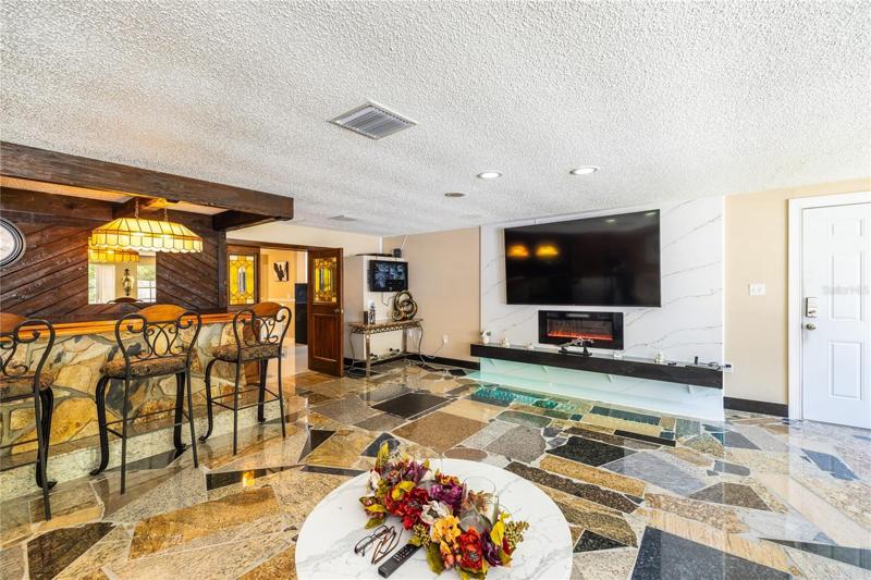 Family room measures 24x 24 with granite flooring.