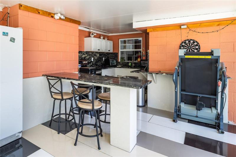 Full function outside kitchen with breakfast bar. quartz countertop cabinets, quartz flooring.