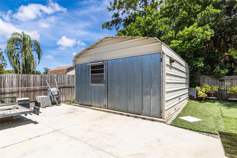 Large shed has electric 110/220 power and water for projects or used as storage.