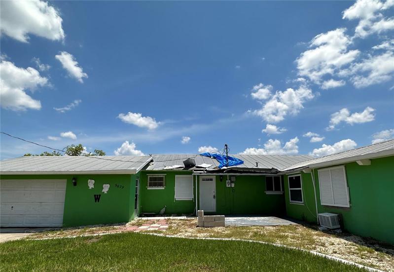 Front View showing damage to middle of roof