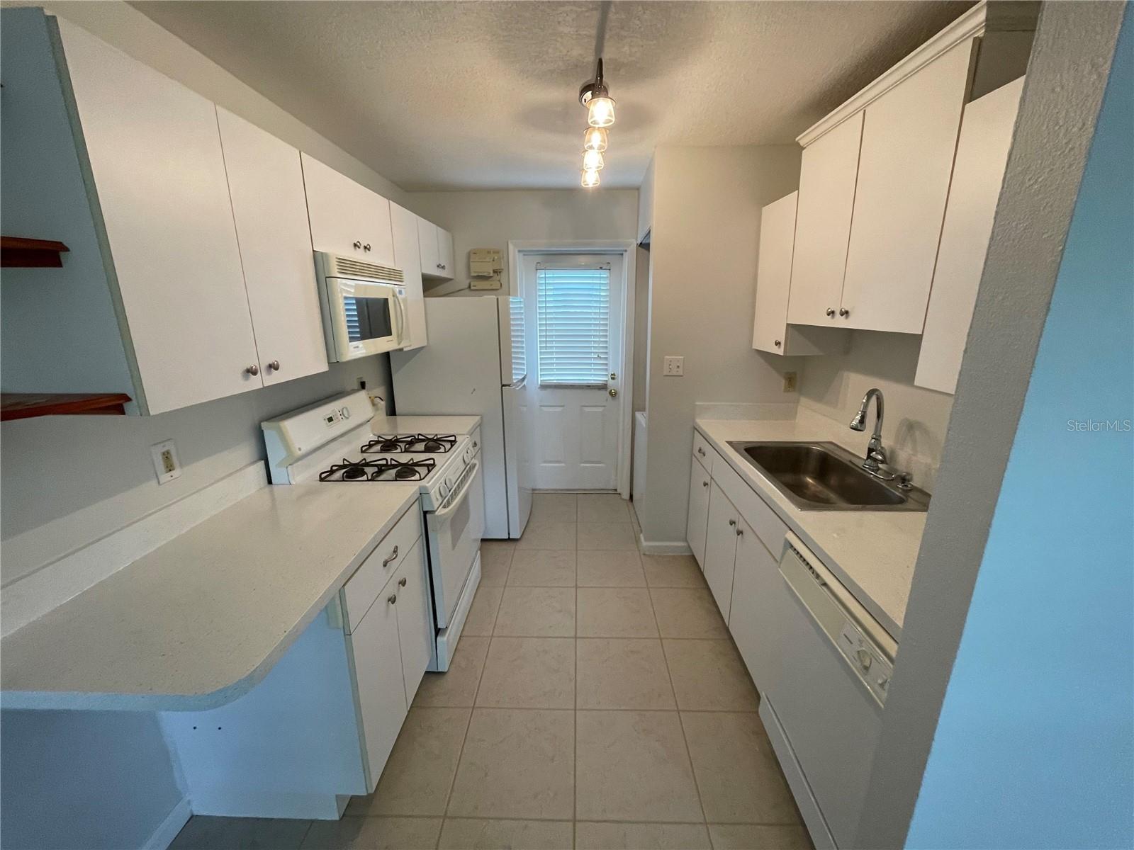 Kitchen with back door entry from private fenced in area