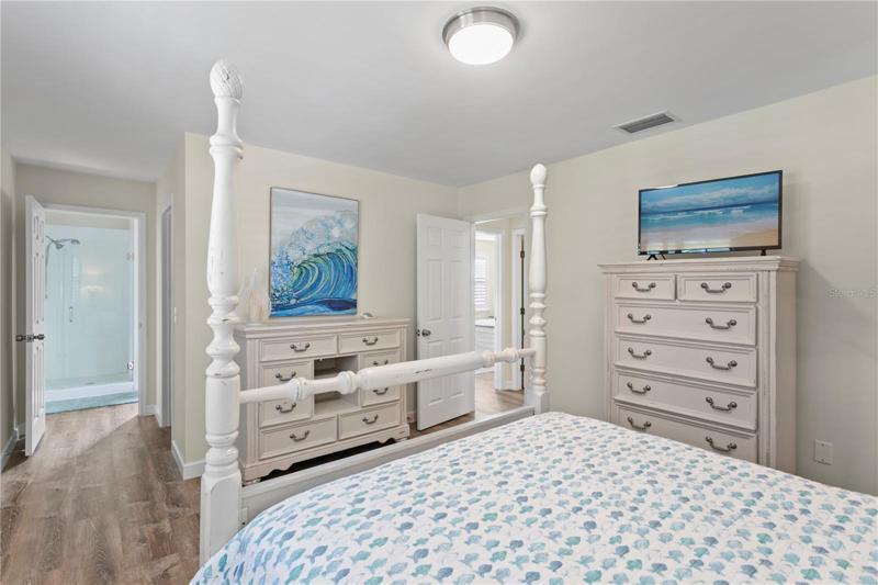 Shower straight ahead and pass by the walk in closet on the way to it.