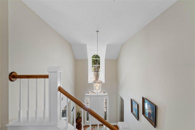 View of dormer window and foyer from top of staircase