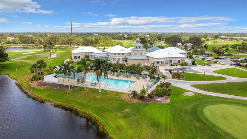 Clubhouse and Pool surrounded by golf course views and lust tropical landscaping