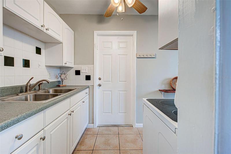 Kitchen with door to carport