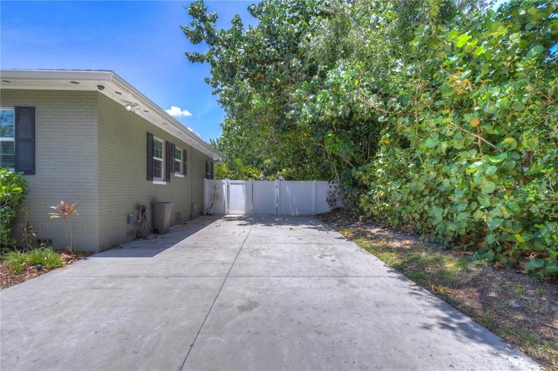 Concrete drive leads to back entry garage