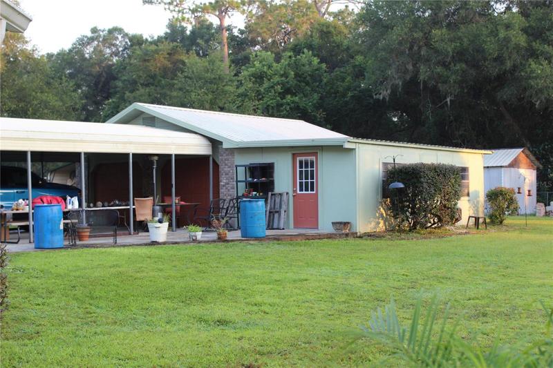 Rear yard view of garage/carport/shop