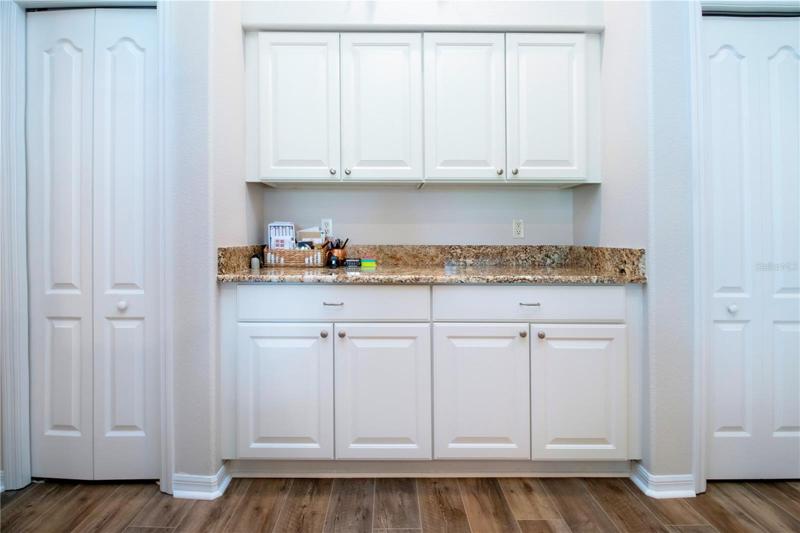 Double pantries with lighted countertop and cabinets between the two pantries