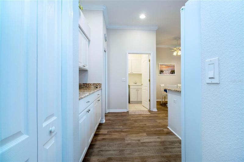 View of the kitchen off the foyer hallway to the laundry room